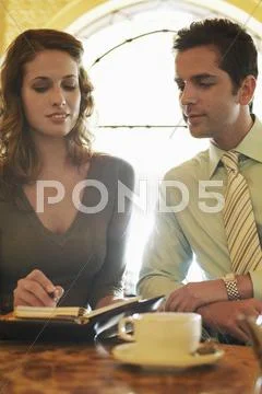 Business People Preparing Schedule At Cafe Stock Photos