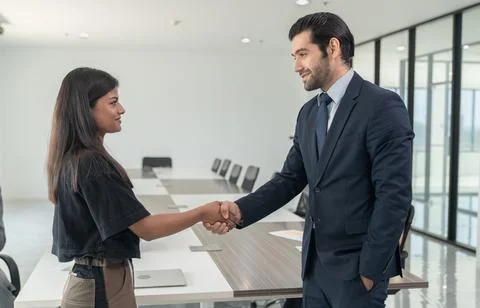 Business people shaking hands after success meeting in office Stock Photos