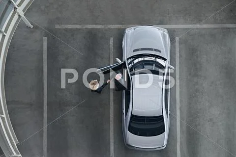 Business People Shaking Hands By A Car