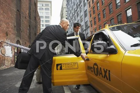 Business People Sharing Taxi Cab, New York City, New York, Usa