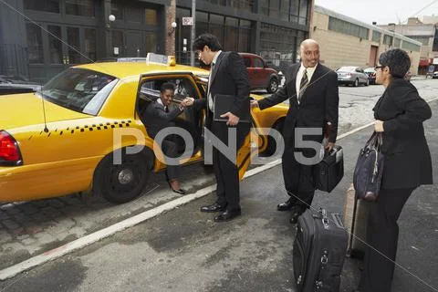Business People Sharing Taxi Cab, New York City, New York, Usa
