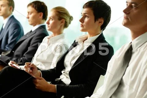 Business people sitting in a row at seminar Stock Photos