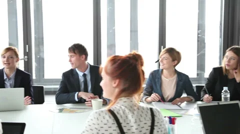 Business people sitting at table while female colleague giving presentation Stock Footage 59544632