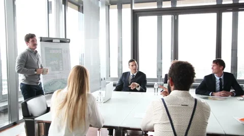 Business people sitting at table while male colleague giving presentation Stock Footage 59544643