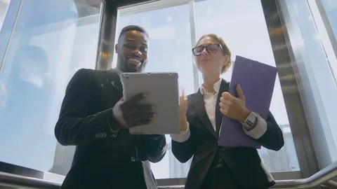 Business people talking in elevator Video stock 121144845