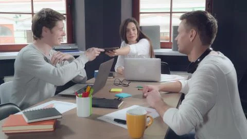 Business people talking using gadgets indoors. Stock Photos