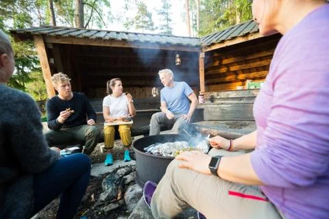Business People Talking While Having Lunch In Forest Stock Photos