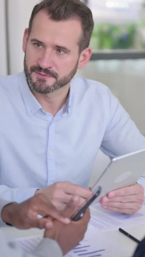 Business People Talking while using Tablet and Smartphone, Vertical Video Stock Footage 340037952