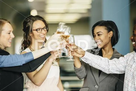 Business People Toasting With Wine In Office