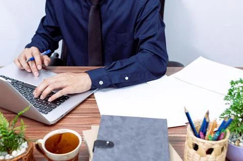 Business people use computers to work at their desks Stock Photos