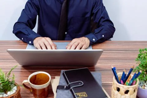 Business people use computers to work at their desks Stock Photos