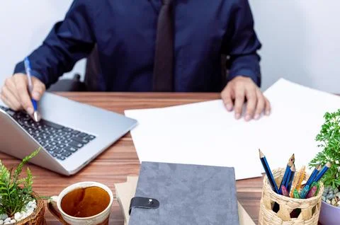 Business people use computers to work at their desks Stock Photos