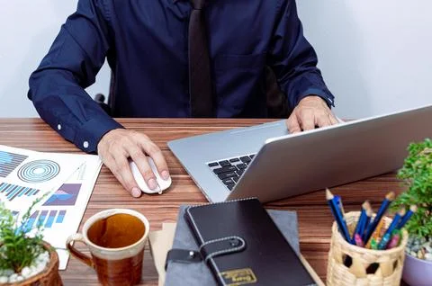 Business people use computers to work at their desks Stock Photos