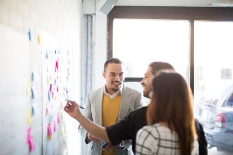 Business people using adhesive notes in office Stockfoto's