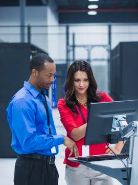 Business people using computer in server room Foto stock