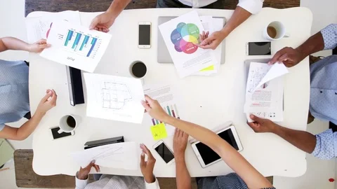 Business people using computers at a desk, overhead shot Stock Footage 78939268