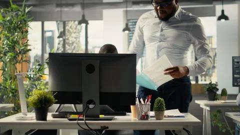 Business people using computers in workspace and analyzing projections Stockfoto's