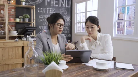 Business people using digital tablet together Stock Footage 135956273