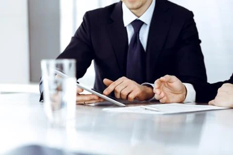 Business people using tablet computer while working together in modern office Stock Photos