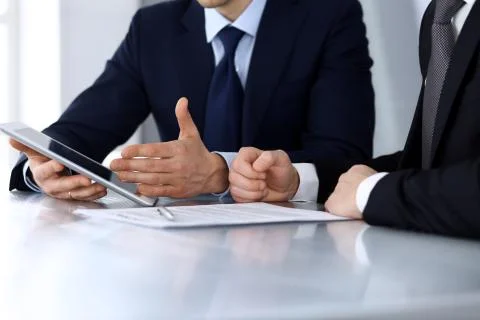 Business people using tablet computer while working together at the desk in Stock Photos