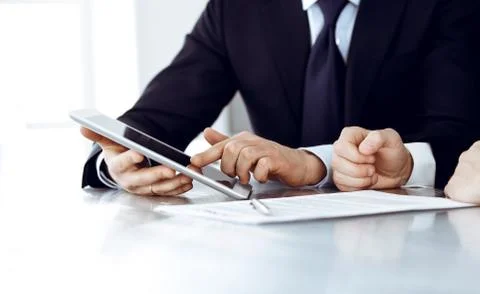 Business people using tablet computer while working together in modern office Stock Photos