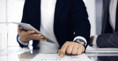 Business people using tablet computer while working together in modern office Stock Photos