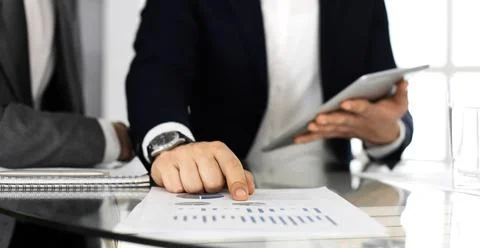 Business people using tablet computer while working together in modern office Stock Photos