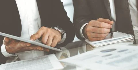 Business people using tablet computer while working together in modern office Stock Photos