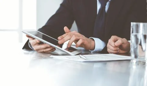 Business people using tablet computer while working together in modern office Stock Photos
