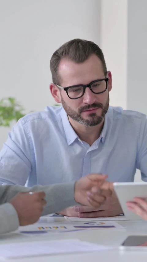 Business People using Tablet While Preparing Reports, Vertical Video Stock Footage 340036084