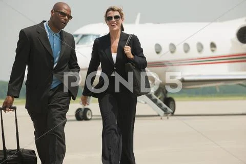 Business People Walking On Airport Tarmac