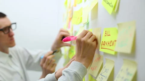 Business people write down an important note, using on the paper stickers post.  Stock Footage 131091642