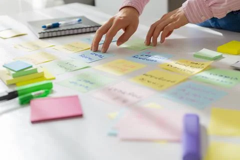  Business people write notes using stickers on paper. Brainstorming concept. Stock Photos