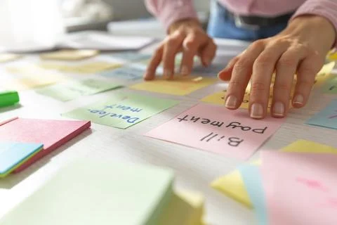 Business people write notes using stickers on paper. Brainstorming concept.  Stock Photos