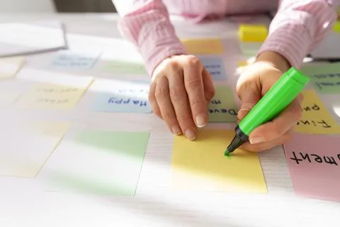 Business people write notes using stickers on paper. Brainstorming concept.  Stock Photos