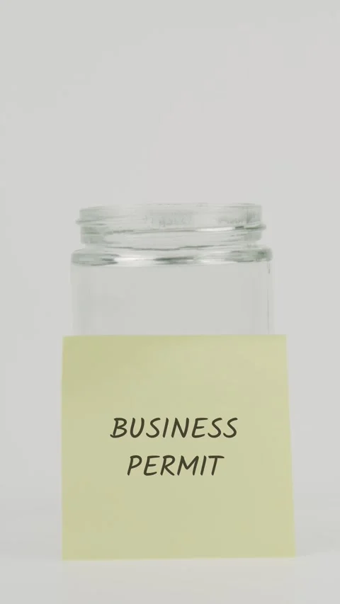 Business permit text or word on yellow sticky note attached to glass jar Stock Footage 311684117