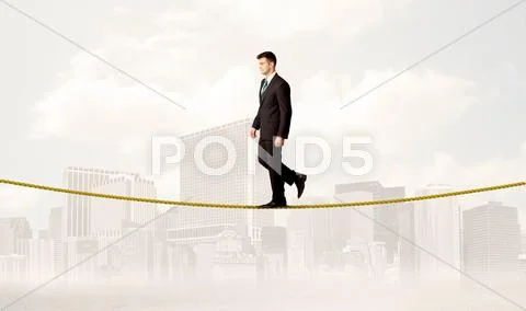 Business person balancing on golden rope Stock Photos