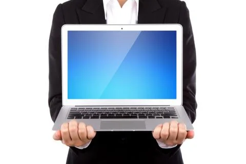Business person holding an open laptop isolated on white background Stock Photos