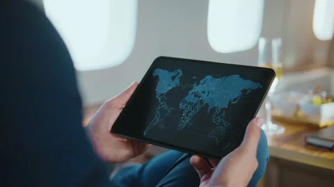 Business person holding a tablet computer with a digital world map display .. Stock-Footage 337601905