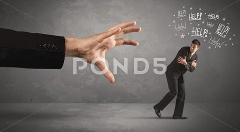 Business person running away from big hand Stock Photos
