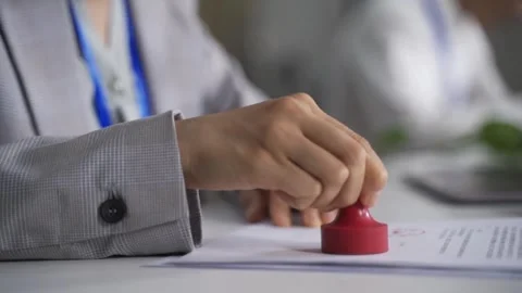 Business person stamping official documents at office desk close up. Stock-Footage 347171663