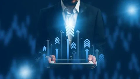 Business person using tablet to analyze data with upward trends in the Stock Photos