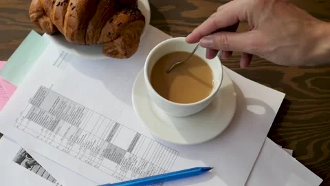 Business planning concept. Notepad, pencil, croissant and coffee on a wooden Vidéo 141486453