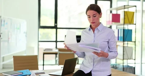 Business problems young dissatisfied female CEO reading reports at workplace and Video stock 252116018