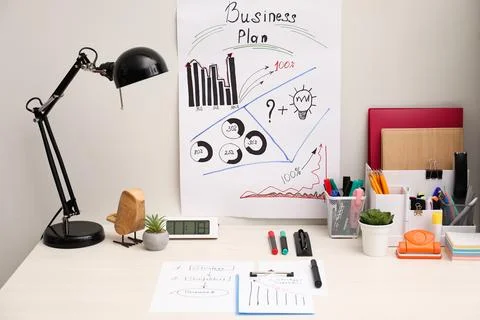 Business process planning and optimization. Workplace with plan, lamp, note.. Stock Photos