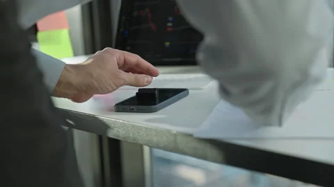 Business professional analyzing data on smartphone at desk Видео 328279689