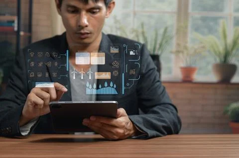 Business Professional Analyzing Digital Data and Graphs on Tablet in Office Stock Photos