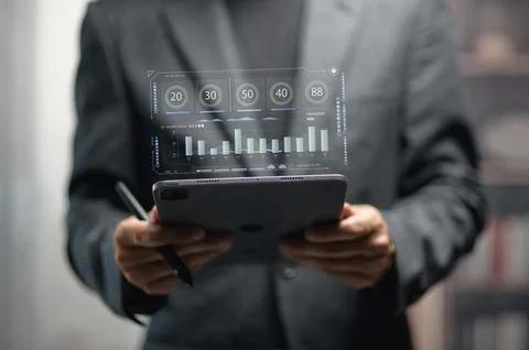 Business Professional Analyzing Digital Data on Tablet in Modern Office Foto stock