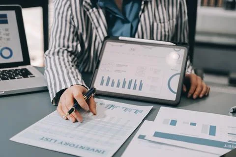 Business professional analyzing financial data on digital tablet dashboard .. Stock Photos