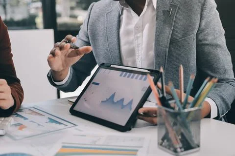 Business professional analyzing financial data on digital tablet dashboard .. Stock Photos
